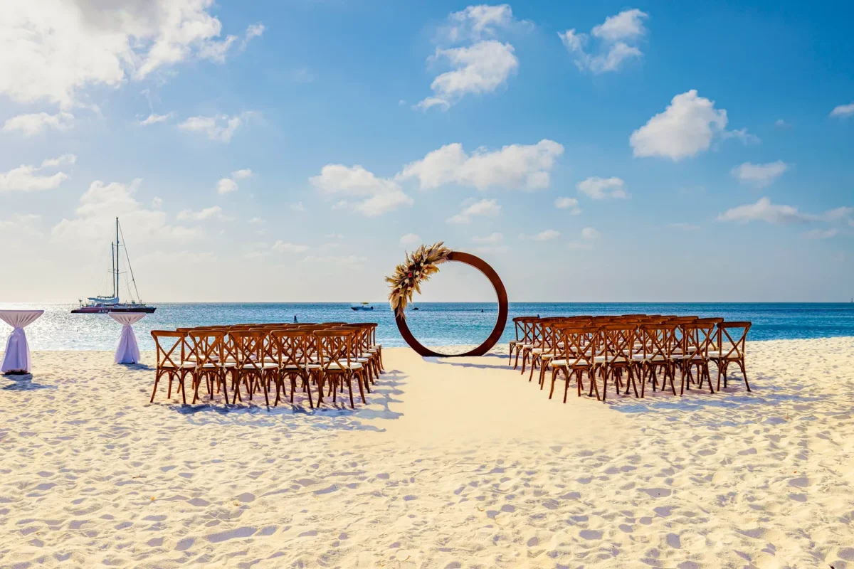 Beach wedding ceremony setup at Hilton Aruba Caribbean Resort. Destination wedding with chairs and ocean view.