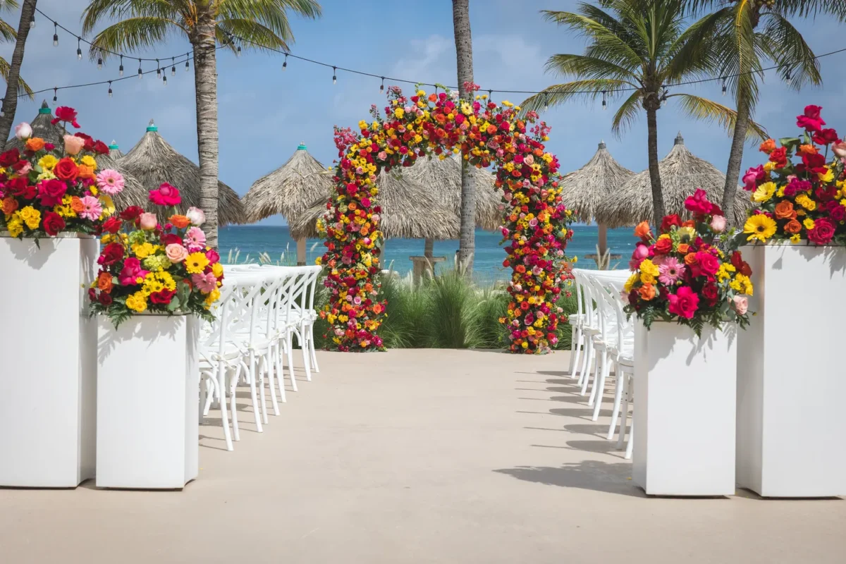 Hilton Aruba Destination Wedding ceremony setup with floral arch and ocean view
