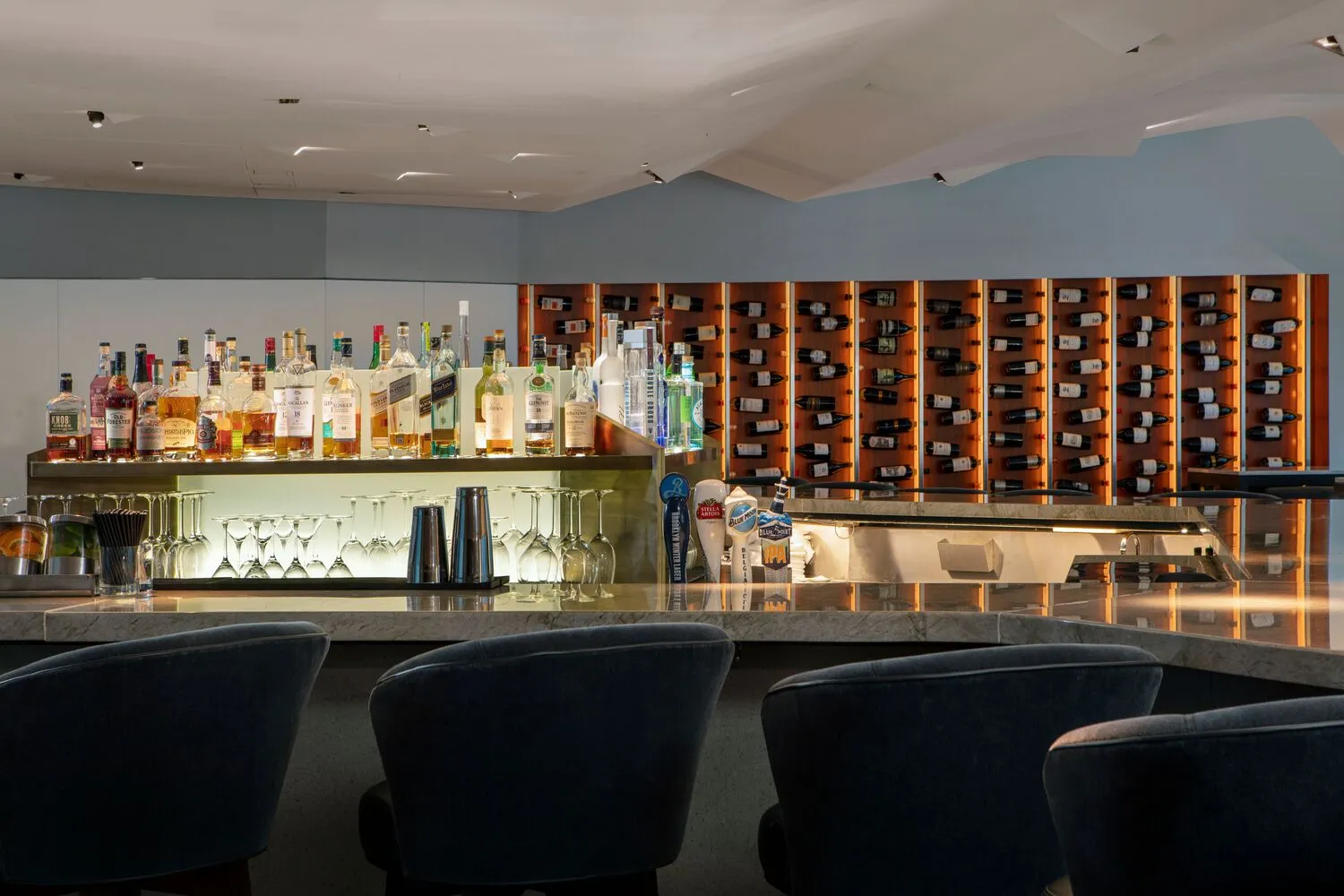 Upscale bar at Conrad New York Downtown, featuring a wine wall and liquor selection. Perfect for NYC wedding receptions.