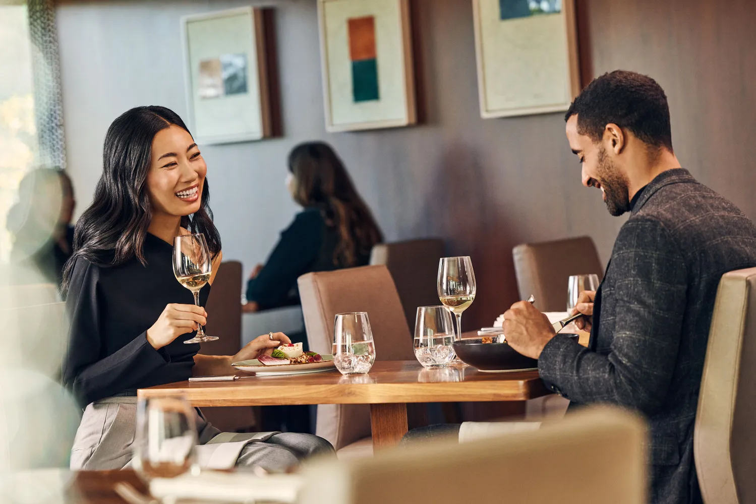 Happy couple enjoying a romantic dinner at Conrad New York Downtown.