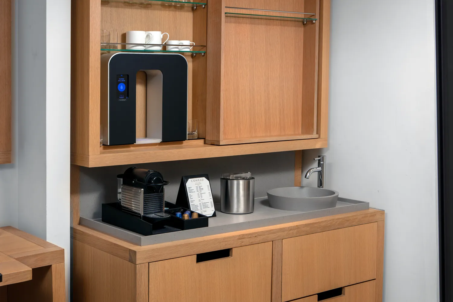 Modern coffee and water station in a Conrad New York Downtown hotel room.