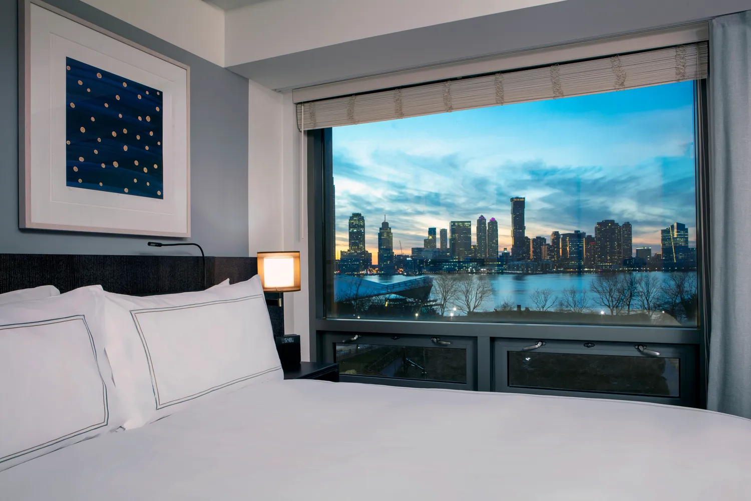 Luxury NYC hotel room with stunning city skyline view at sunset. Ideal for a romantic NYC wedding.