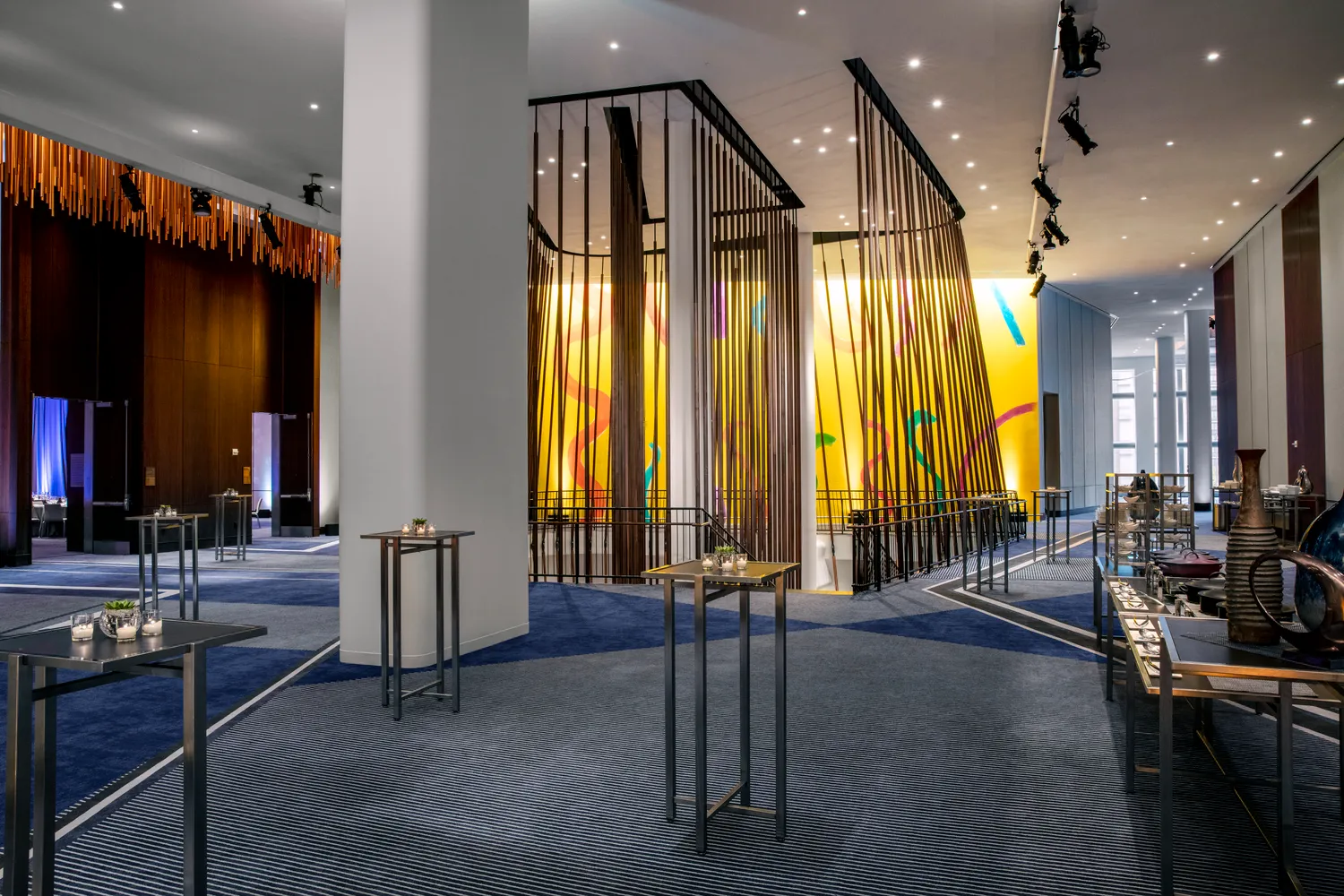 Modern NYC wedding venue at Conrad New York Downtown. Elegant event space with cocktail tables.