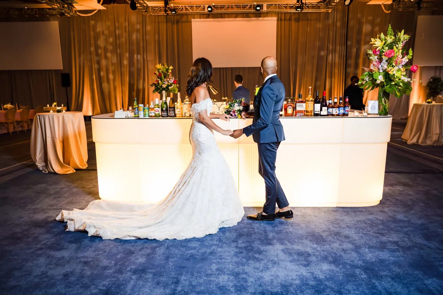 Bride and groom holding hands at a NYC wedding reception.