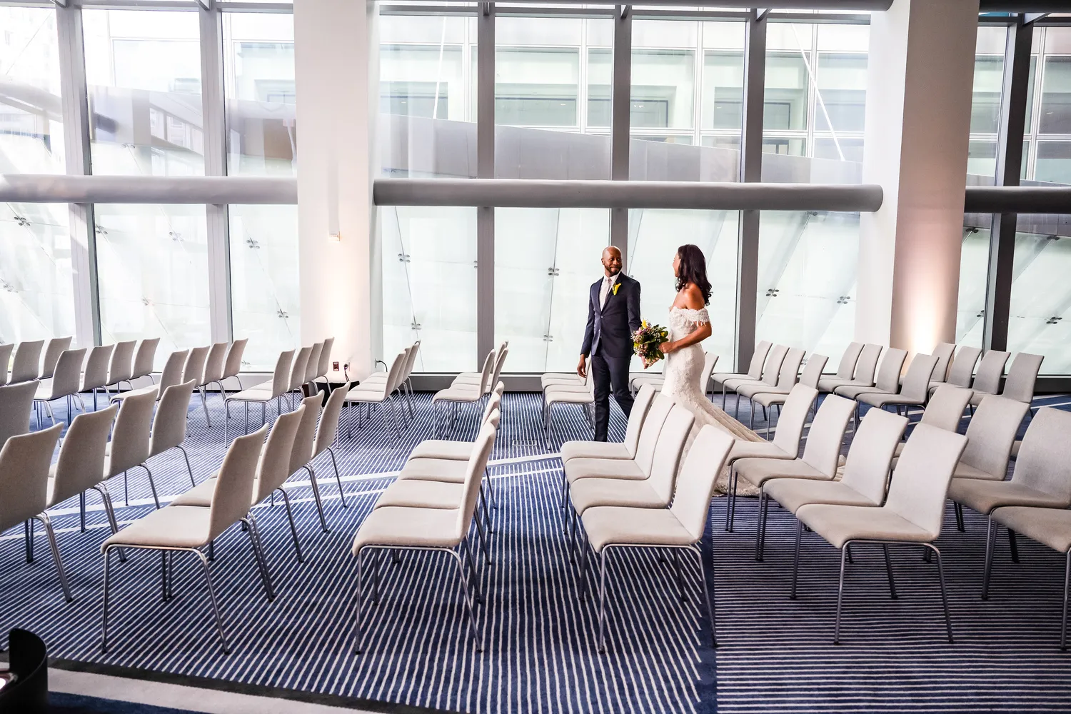 Bride and groom walking down the aisle at a modern NYC wedding ceremony at the Conrad New York Downtown.
