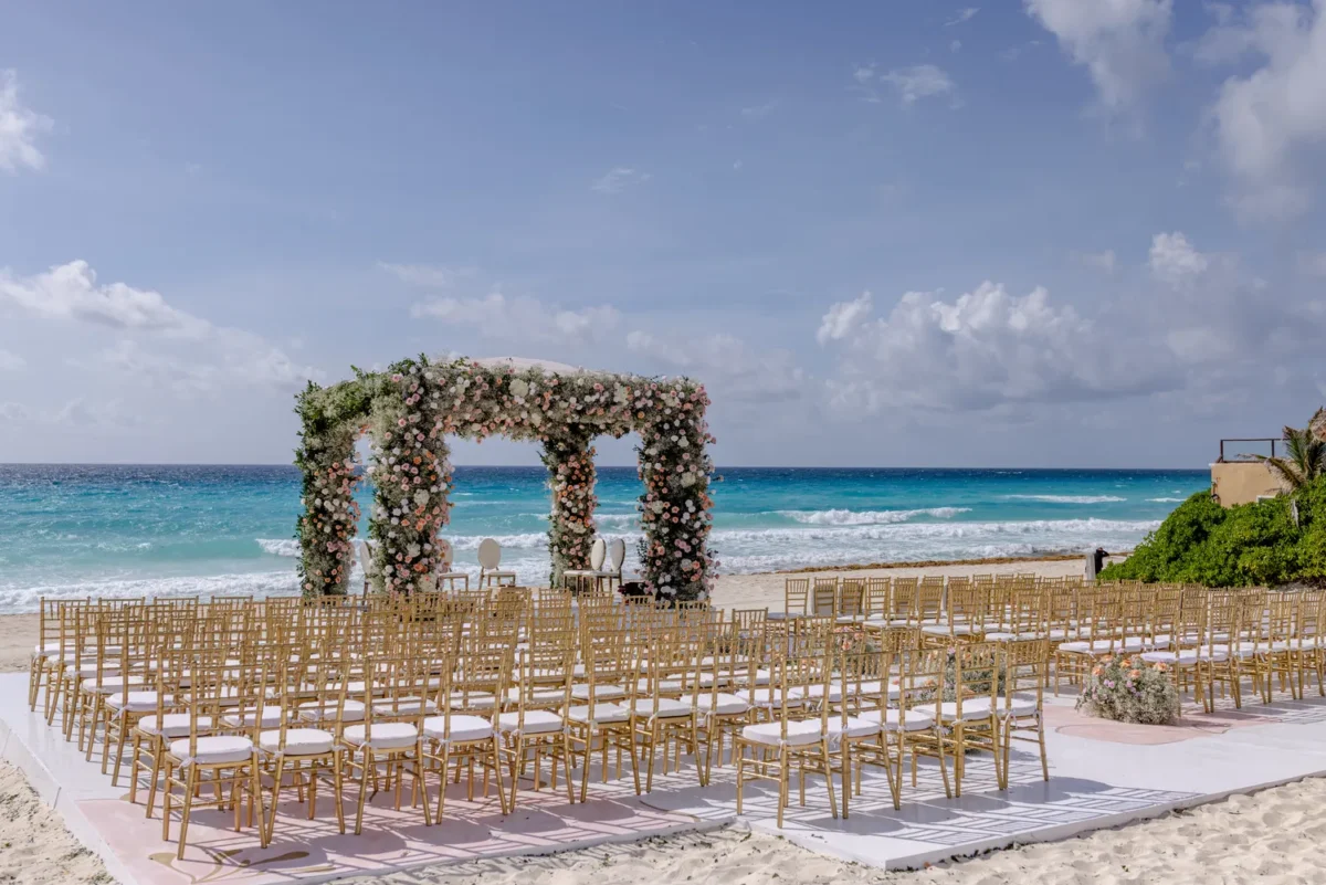 Beachfront wedding ceremony setup at Kempinski Hotel Cancún, a destination wedding resort.