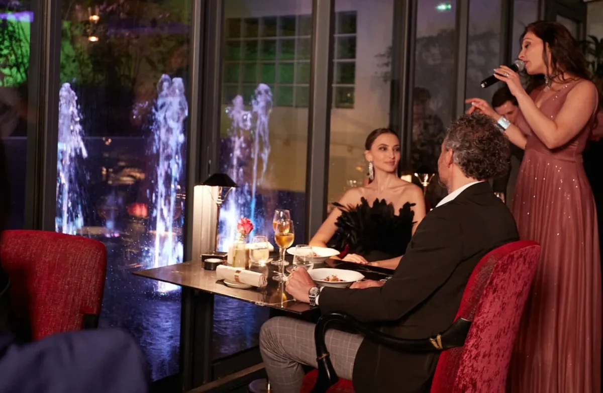 Romantic Paris dinner: couple enjoys a meal overlooking a water feature at the Paris j'Adore Hotel & Spa. Perfect for a honeymoon.