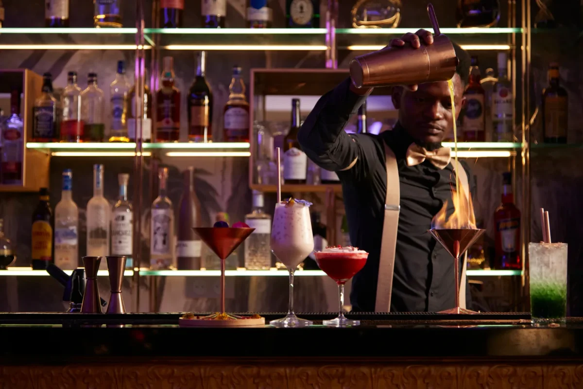 Bartender preparing cocktails at a luxurious Paris bar.