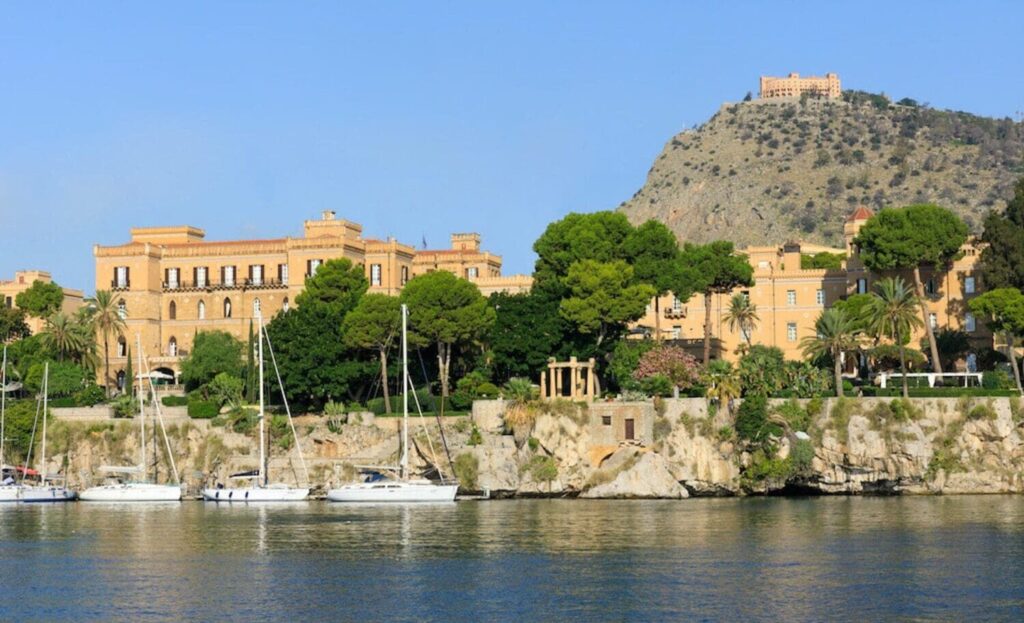 Historic Villa Igiea hotel by the Sicilian coastline surrounded by lush greenery