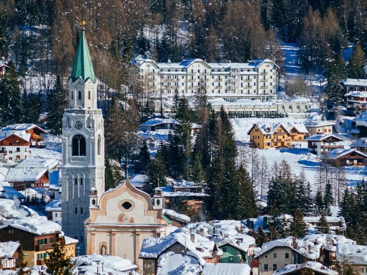 Scenic Italian Alps village covered in snow with a church and rustic homes