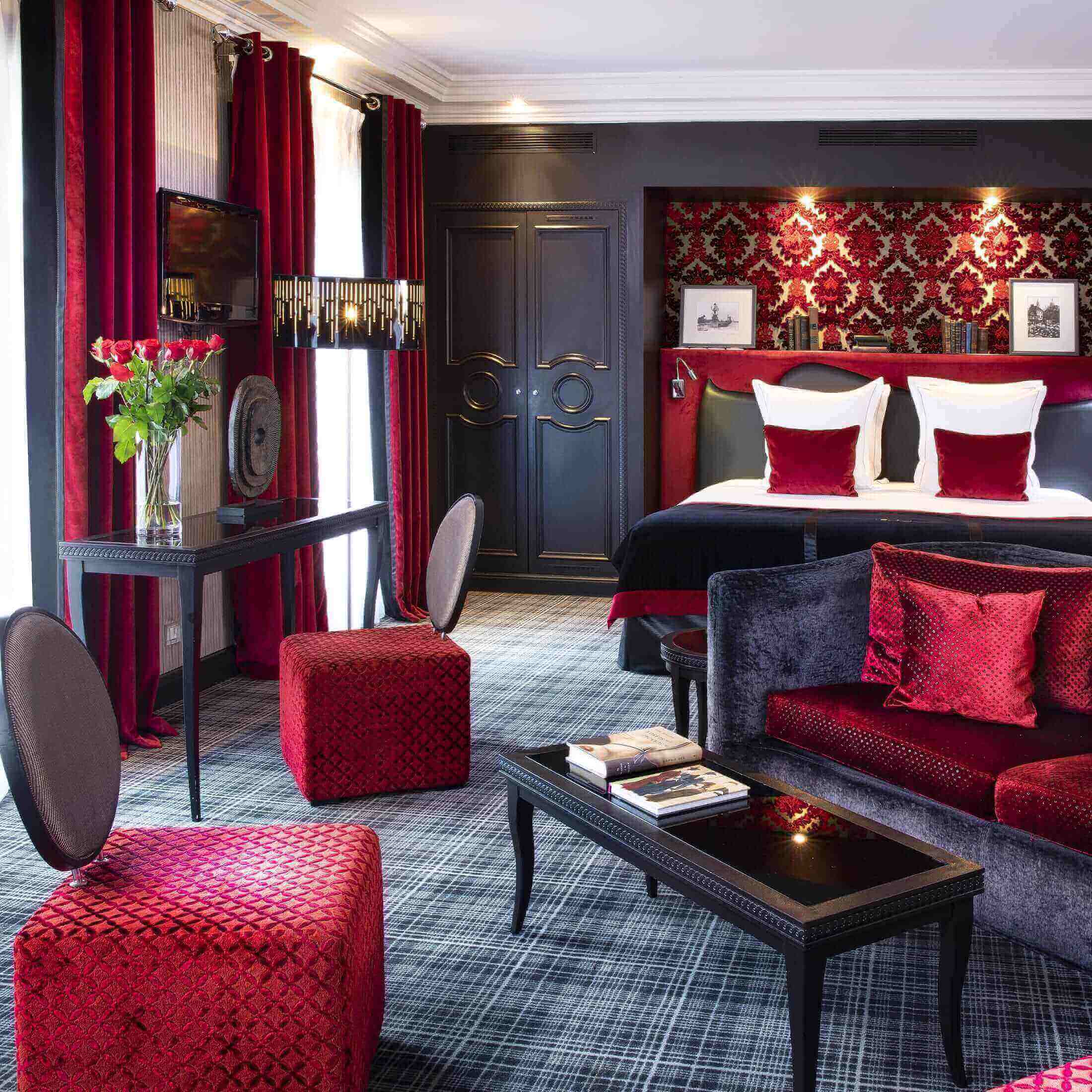 Elegant hotel room with plush red decor and king-size bed