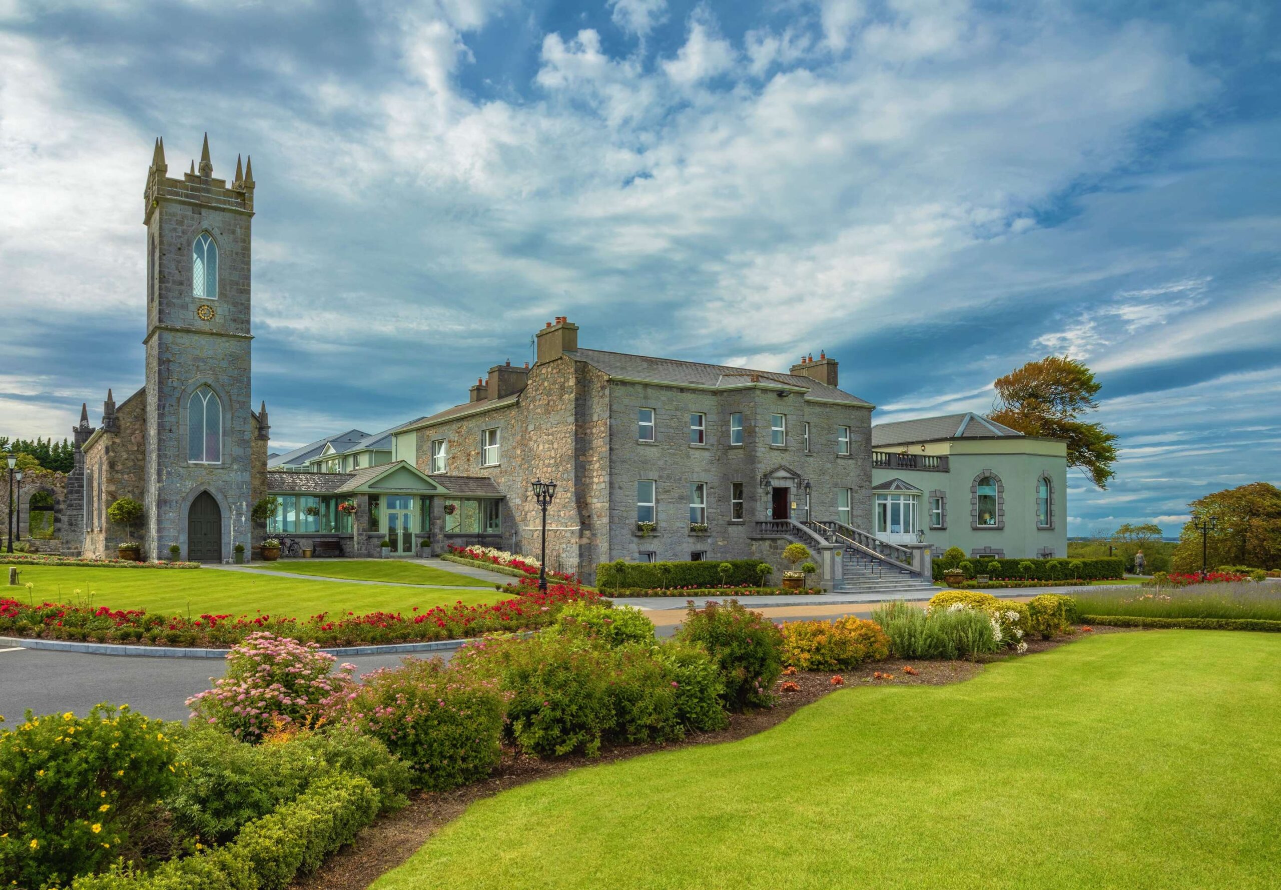Glenlo Abbey Hotel with gardens under a blue sky, perfect for an Ireland wedding