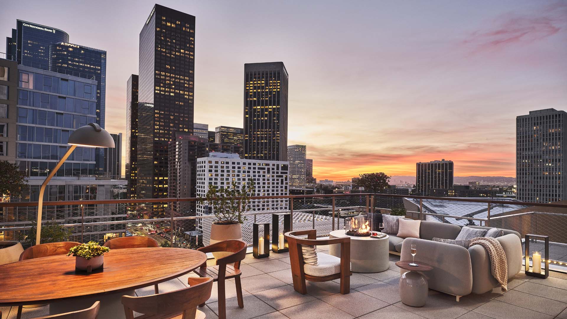 Rooftop terrace at Conrad Los Angeles with LA skyline at sunset