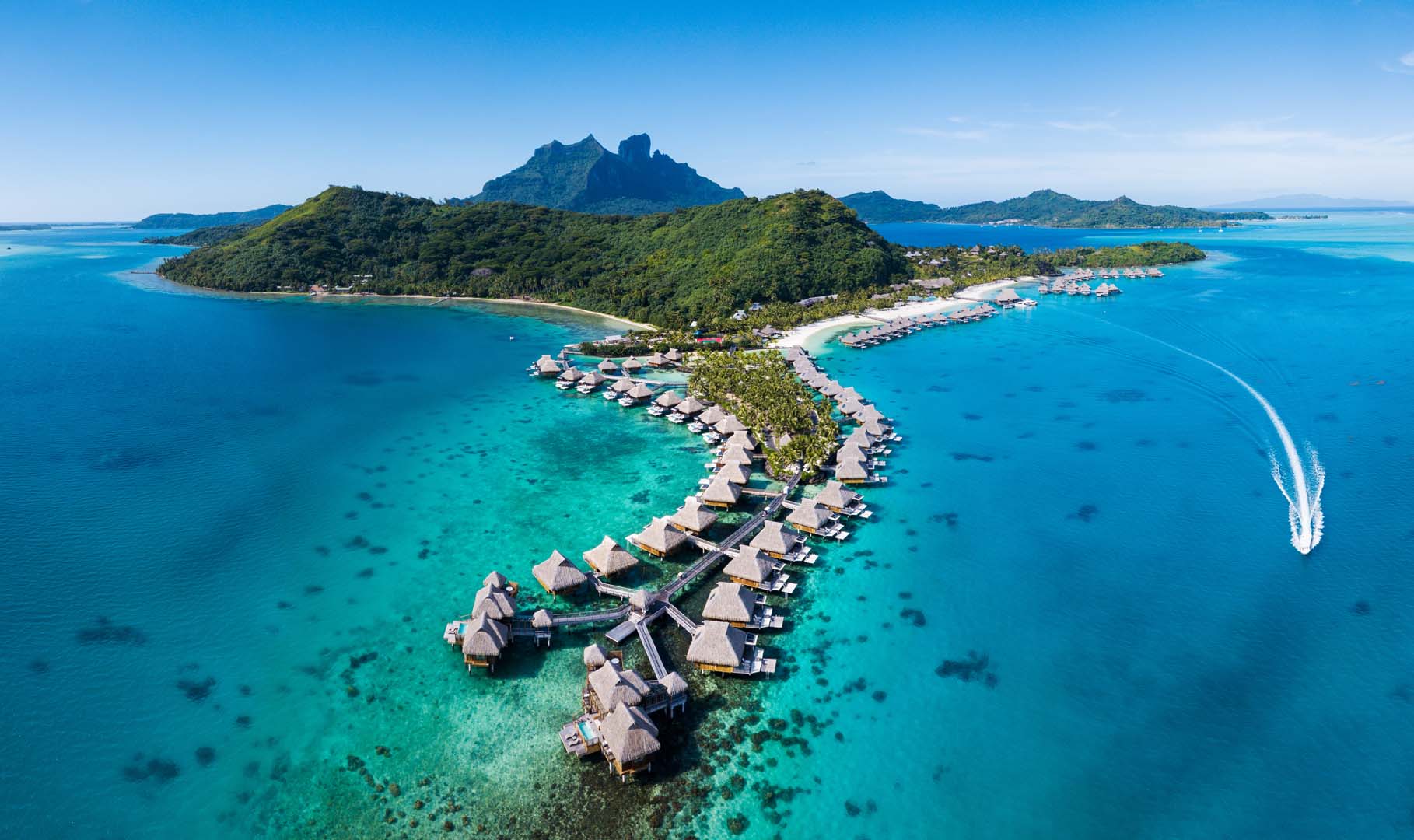 Aerial view of Conrad Bora Bora Nui overwater bungalows and turquoise lagoon
