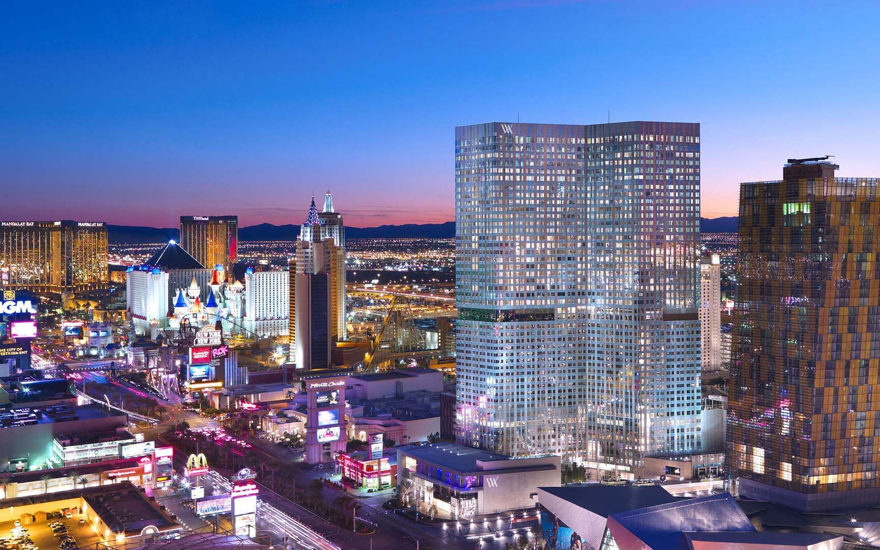 Vegas skyline at dusk, featuring Waldorf Astoria and vibrant city lights