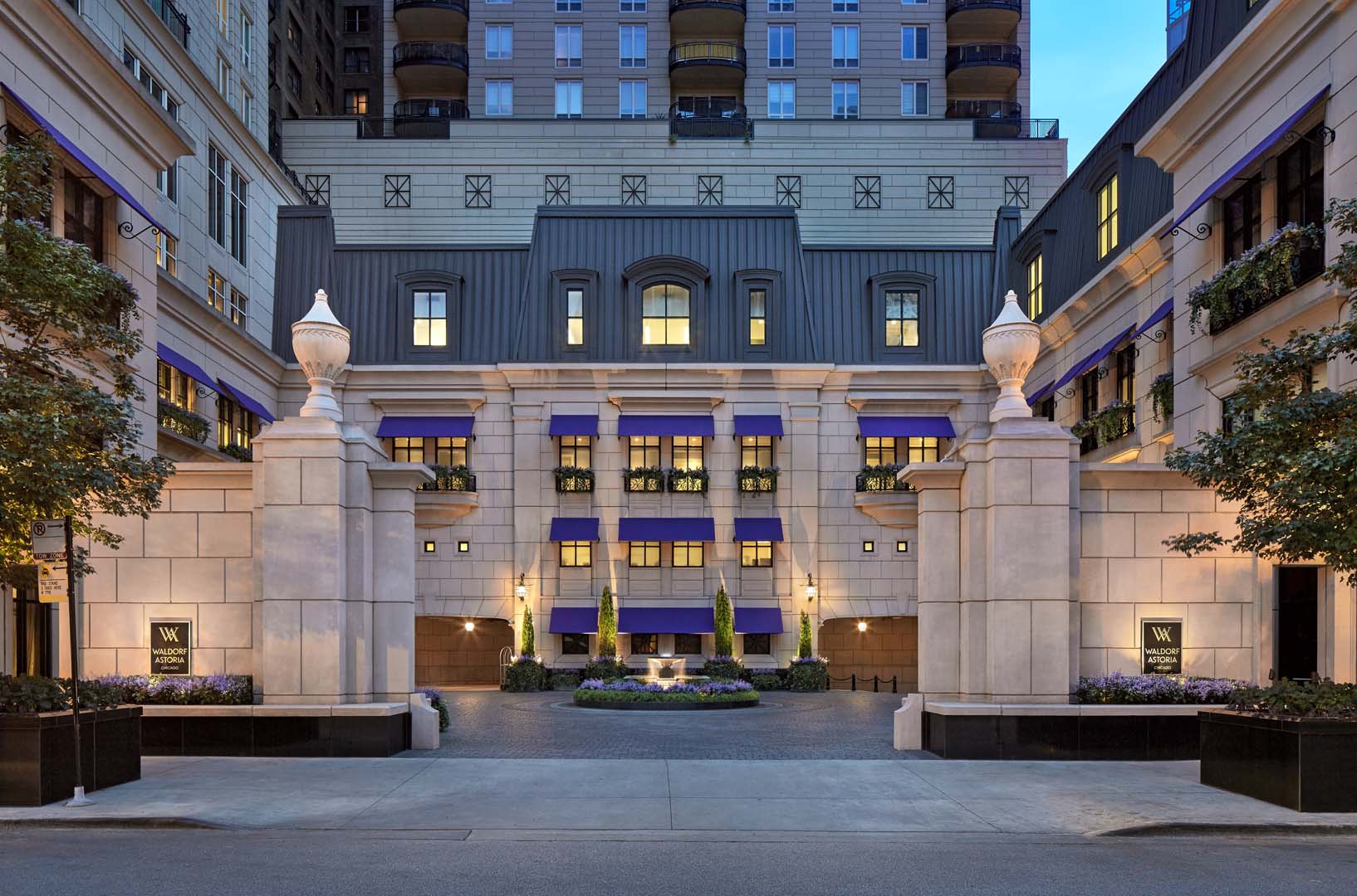 Elegant entrance of Waldorf Astoria Chicago at dusk, ideal for luxury weddings
