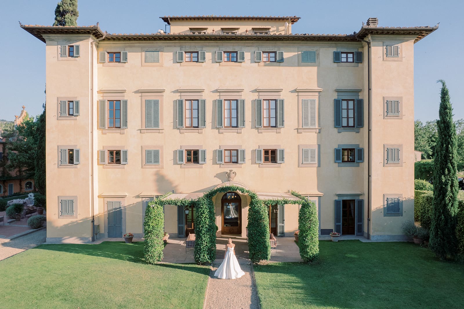Bride in front of Villa La Massa, Tuscany luxury destination wedding venue