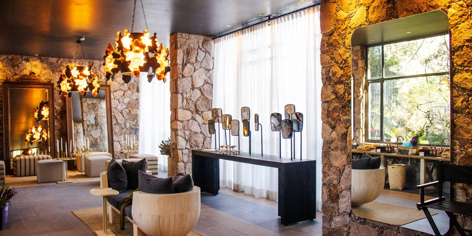 Luxurious Mexican spa reception area with stone walls, unique lighting, and comfortable seating. Perfect for a dream wedding in Mexico.