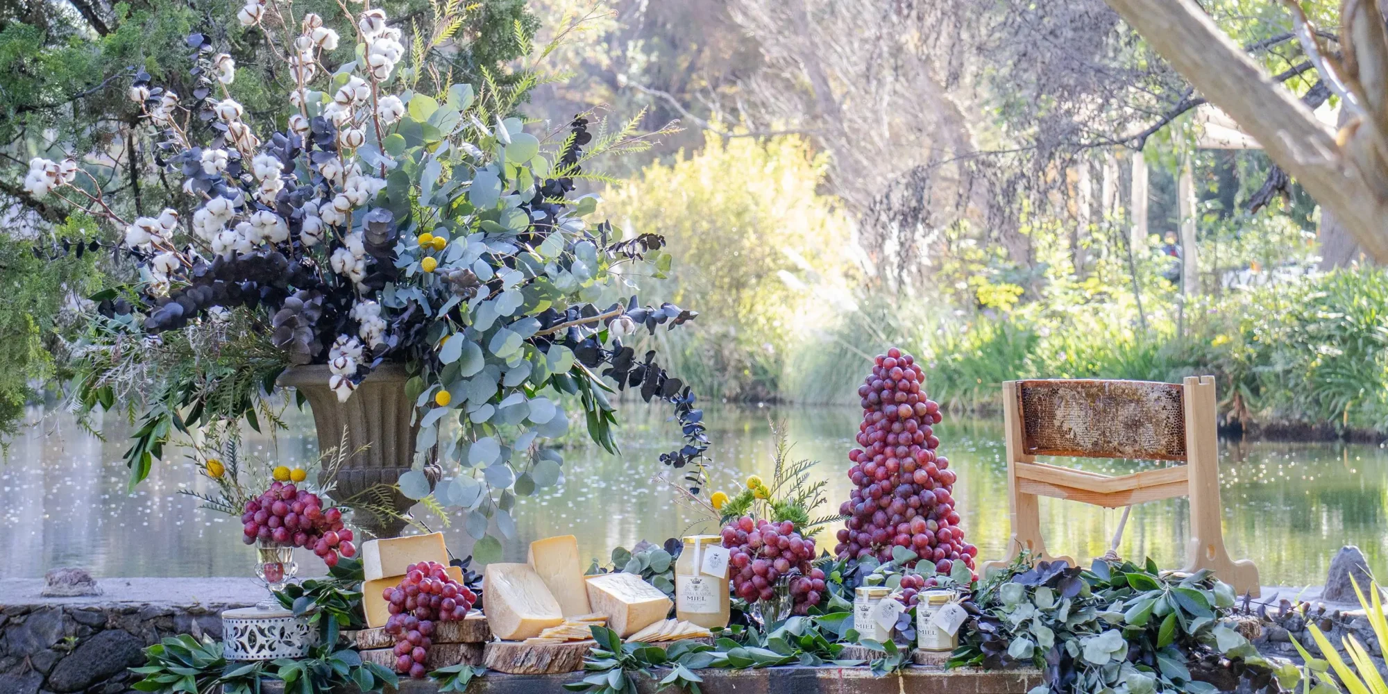 Elegant cheese and honey display with grapes and flowers at a dream wedding in Mexico. #AguaBendita
