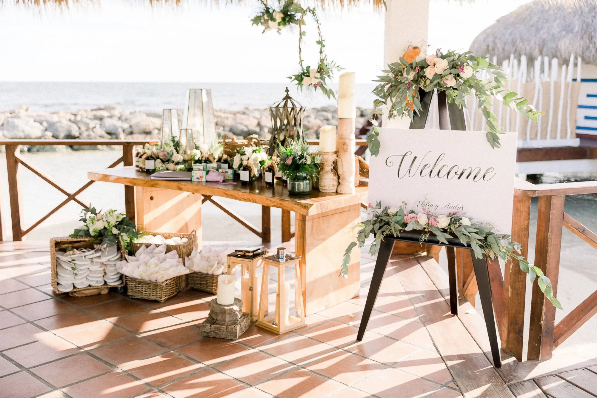 Welcome sign at a Dominican Republic beach wedding, featuring floral arrangements and guest favors.