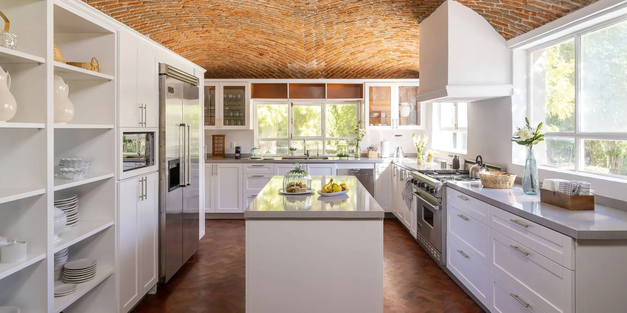 Bright, spacious kitchen with white cabinets and a brick barrel ceiling. Perfect for a dream wedding in Mexico.