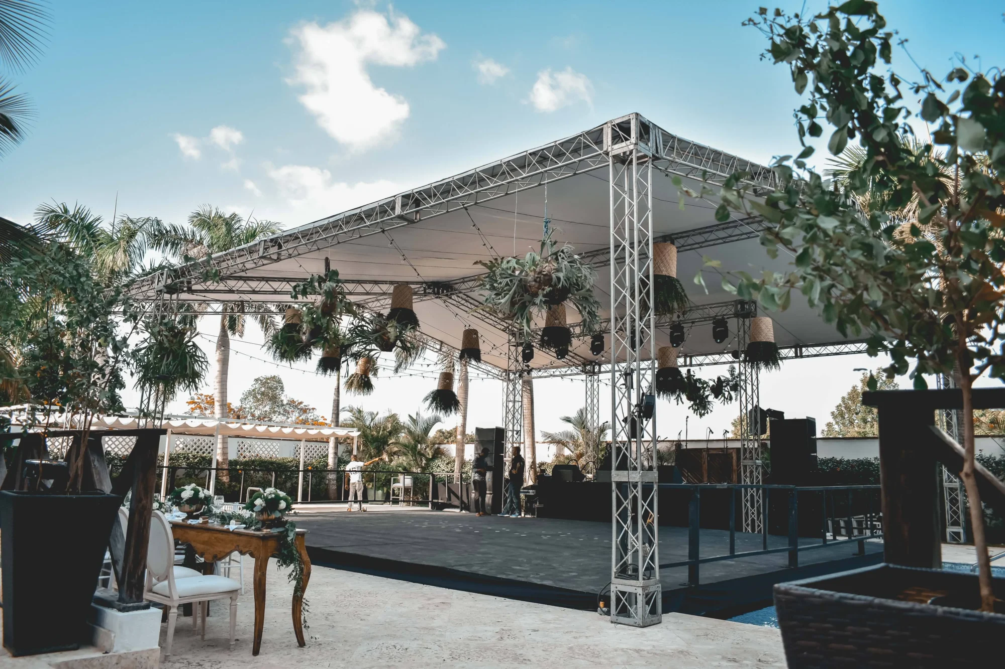 Outdoor wedding ceremony setup at a Dominican Republic boutique hotel. Elegant stage with tropical plants.