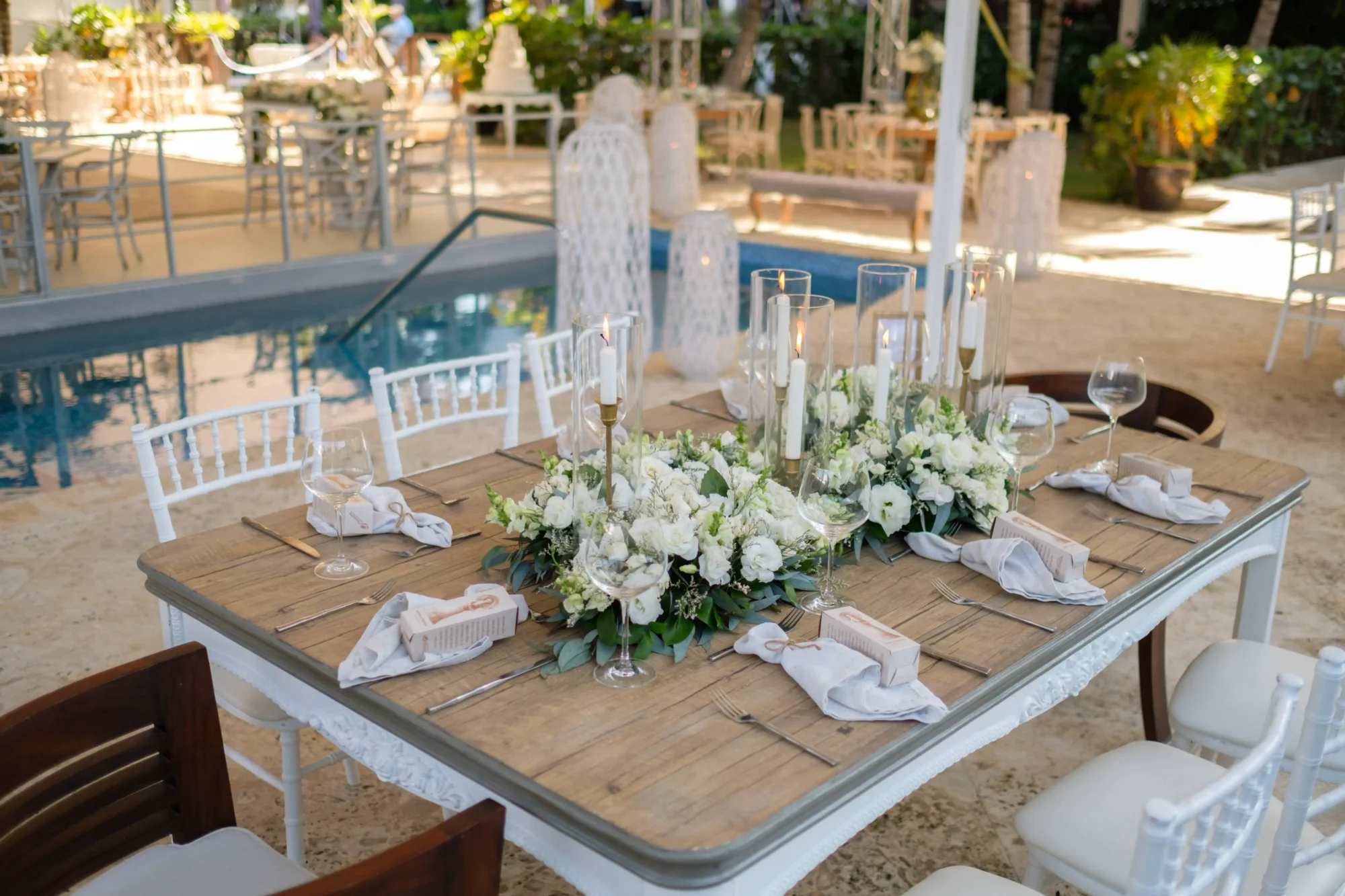 Romantic wedding table setting at a Dominican Republic boutique hotel. White flowers and candles.