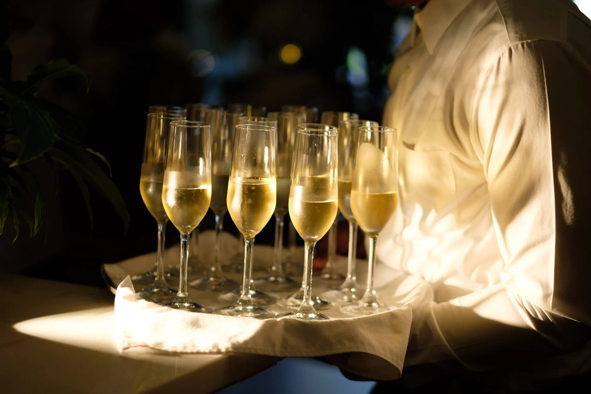 Waiter carrying tray of champagne flutes at a Dominican Republic wedding.