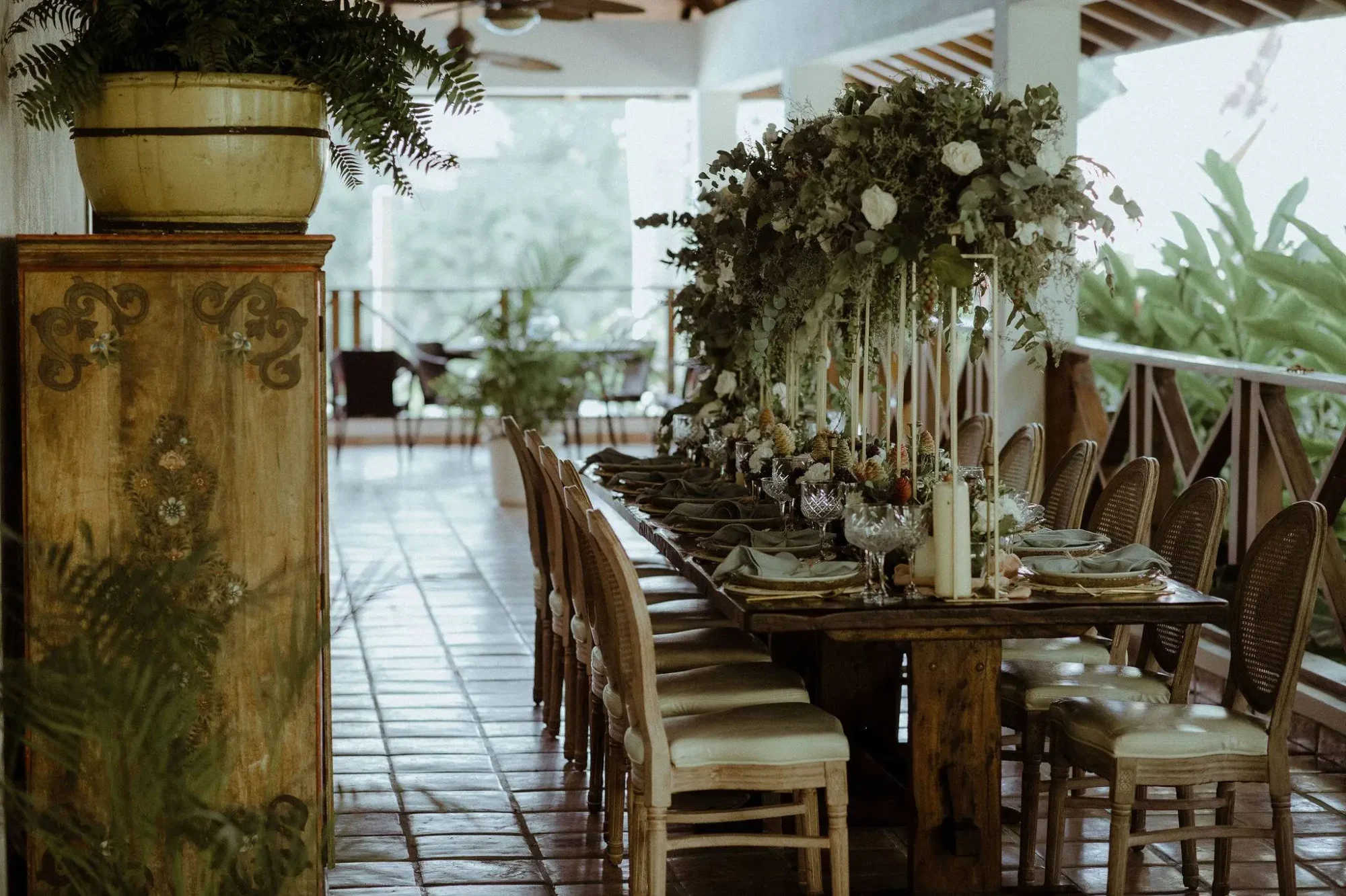 Rustic wooden wedding table with floral centerpiece at Boutique Hotel Casa Hemingway in the Dominican Republic.