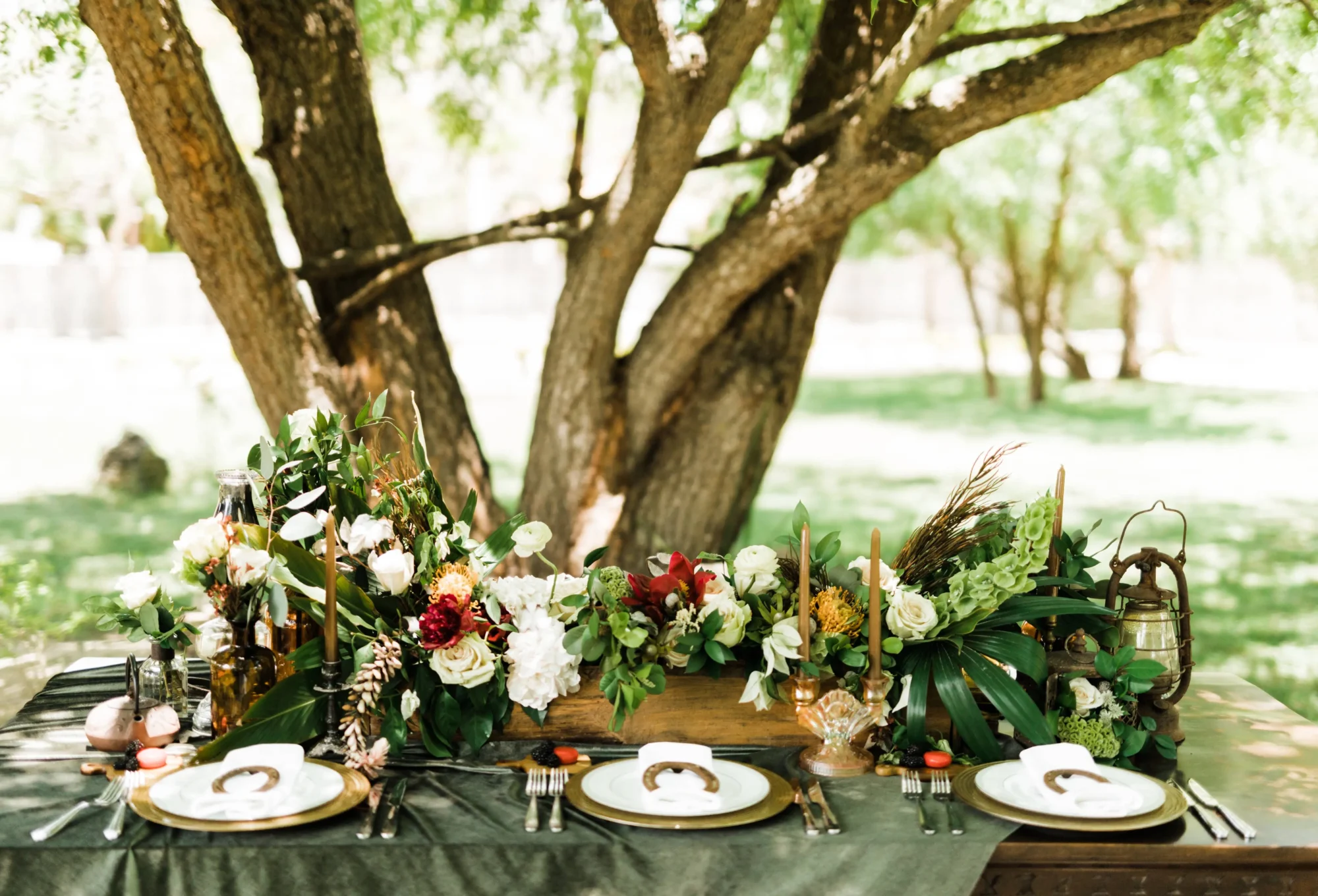 Elegant outdoor wedding reception table setting at a Dominican Republic boutique hotel. Lush floral centerpiece.