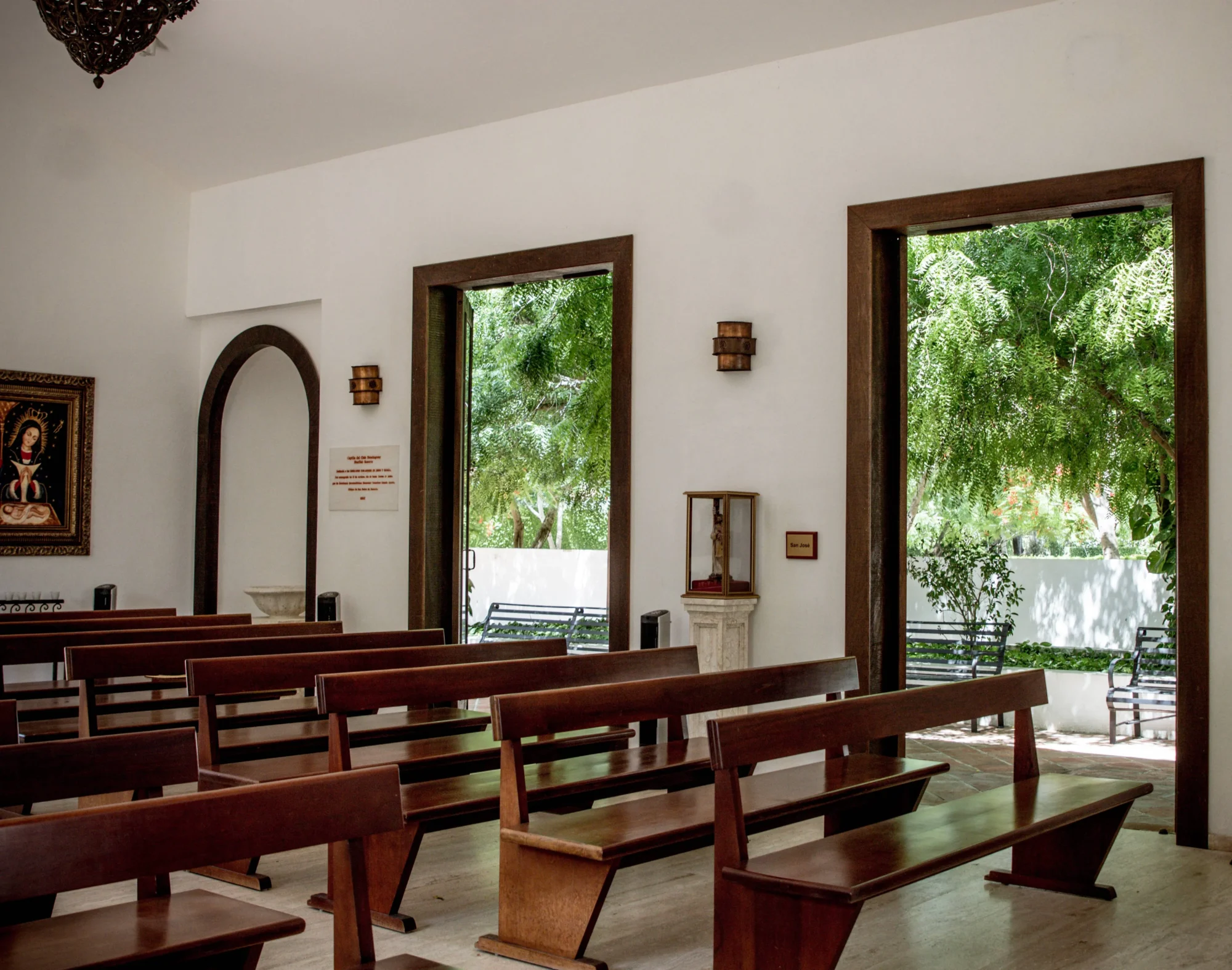 Simple chapel with wooden pews and garden views, perfect for a Dominican Republic wedding at Casa Hemingway.