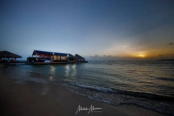Sunset over ocean, beachfront restaurant at Dominican Republic wedding venue.