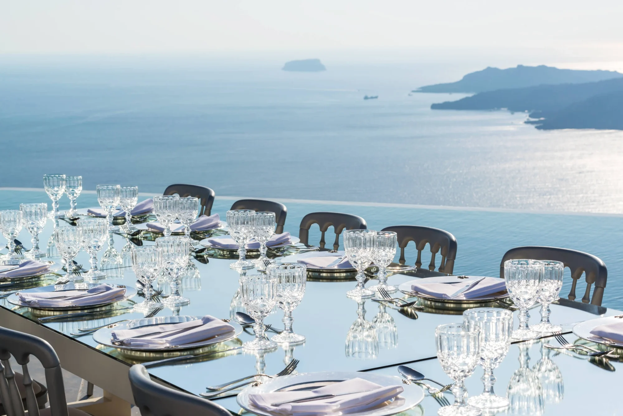 Elegant wedding table setting overlooking the Santorini caldera. Dream wedding in Santorini.