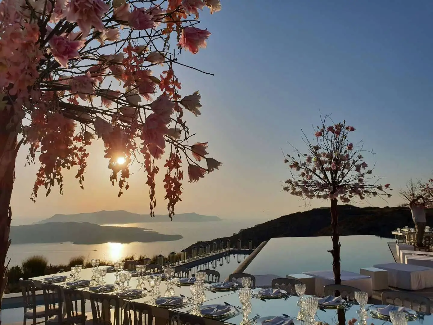 Romantic Santorini wedding reception overlooking the caldera at sunset. Dream wedding in Santorini.