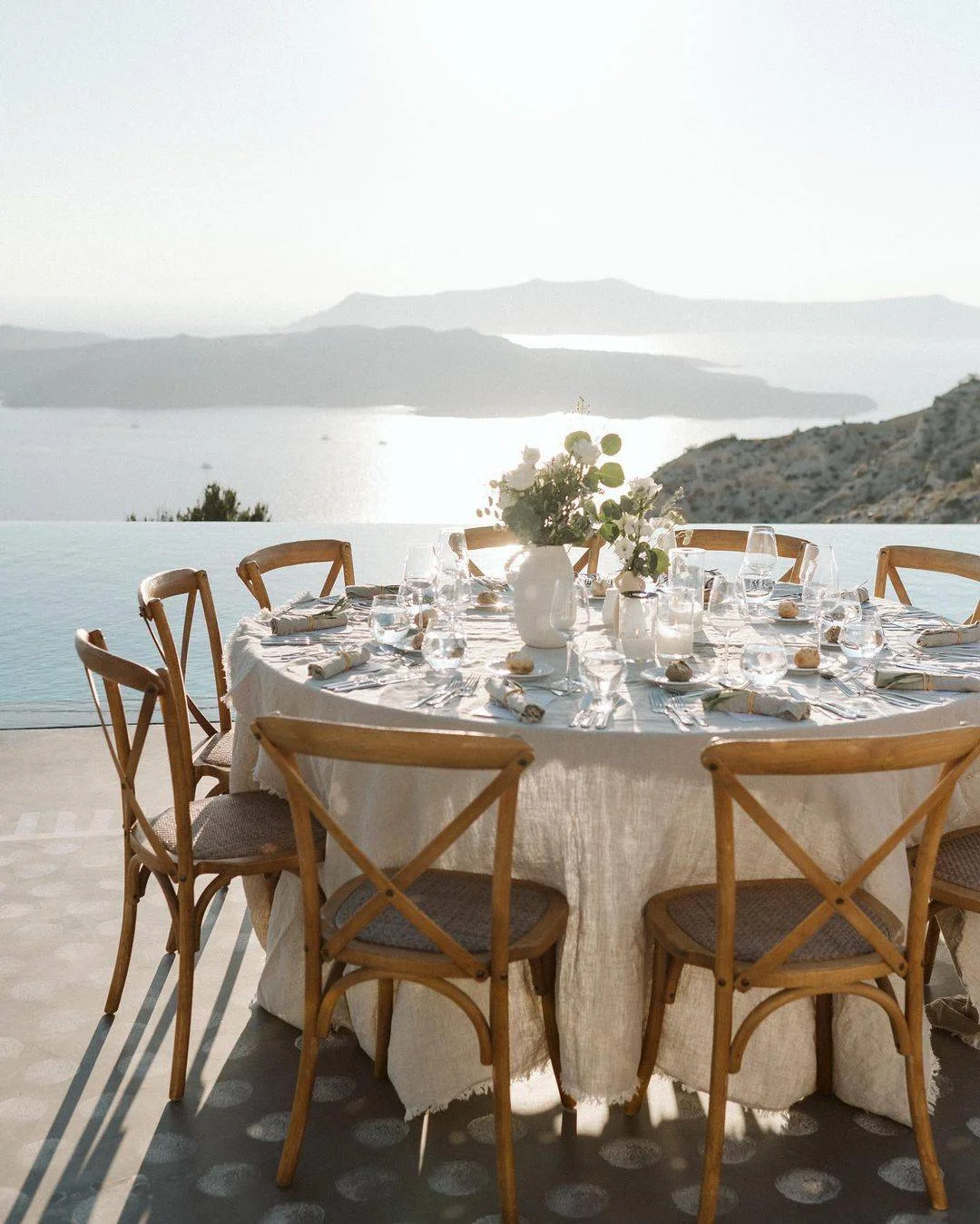 Romantic Santorini wedding reception overlooking the Aegean Sea. Dream wedding in Santorini.