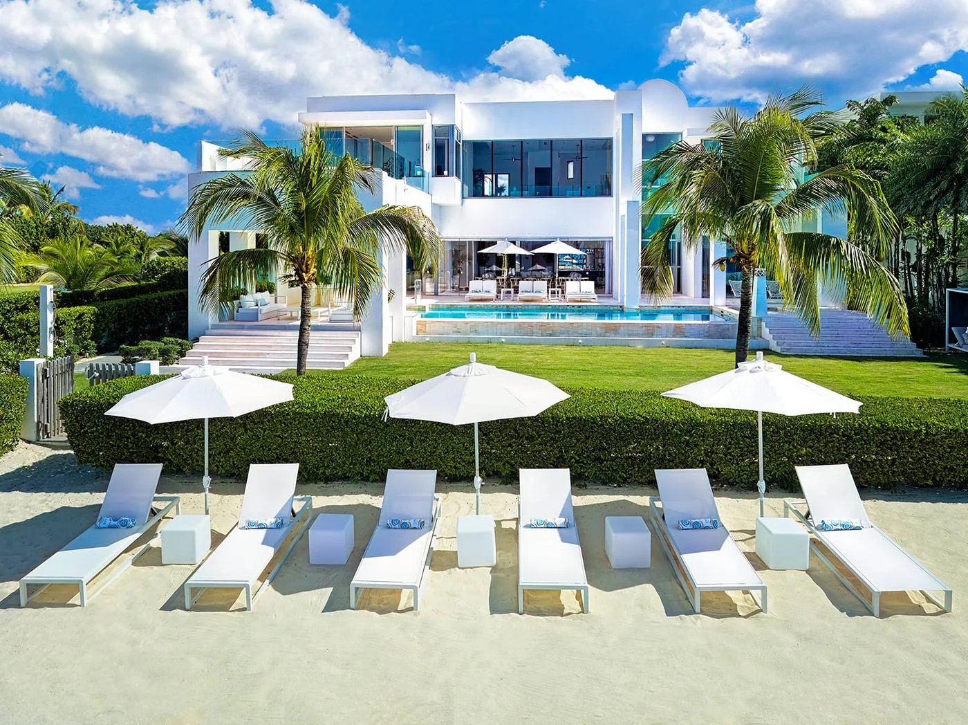 Luxury beachfront villa in Anguilla with pool and beach loungers; perfect Anguilla destination wedding location.