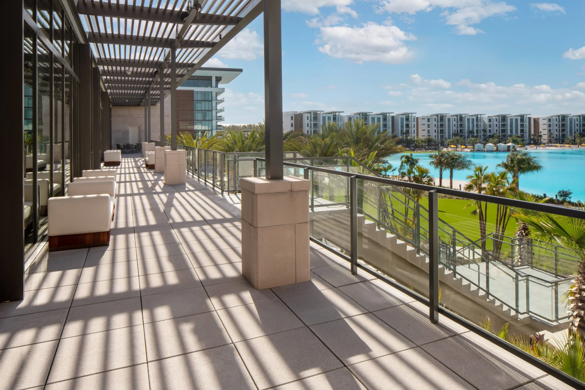 Outdoor terrace at the Conrad Orlando wedding destination, with views of a lagoon and buildings.