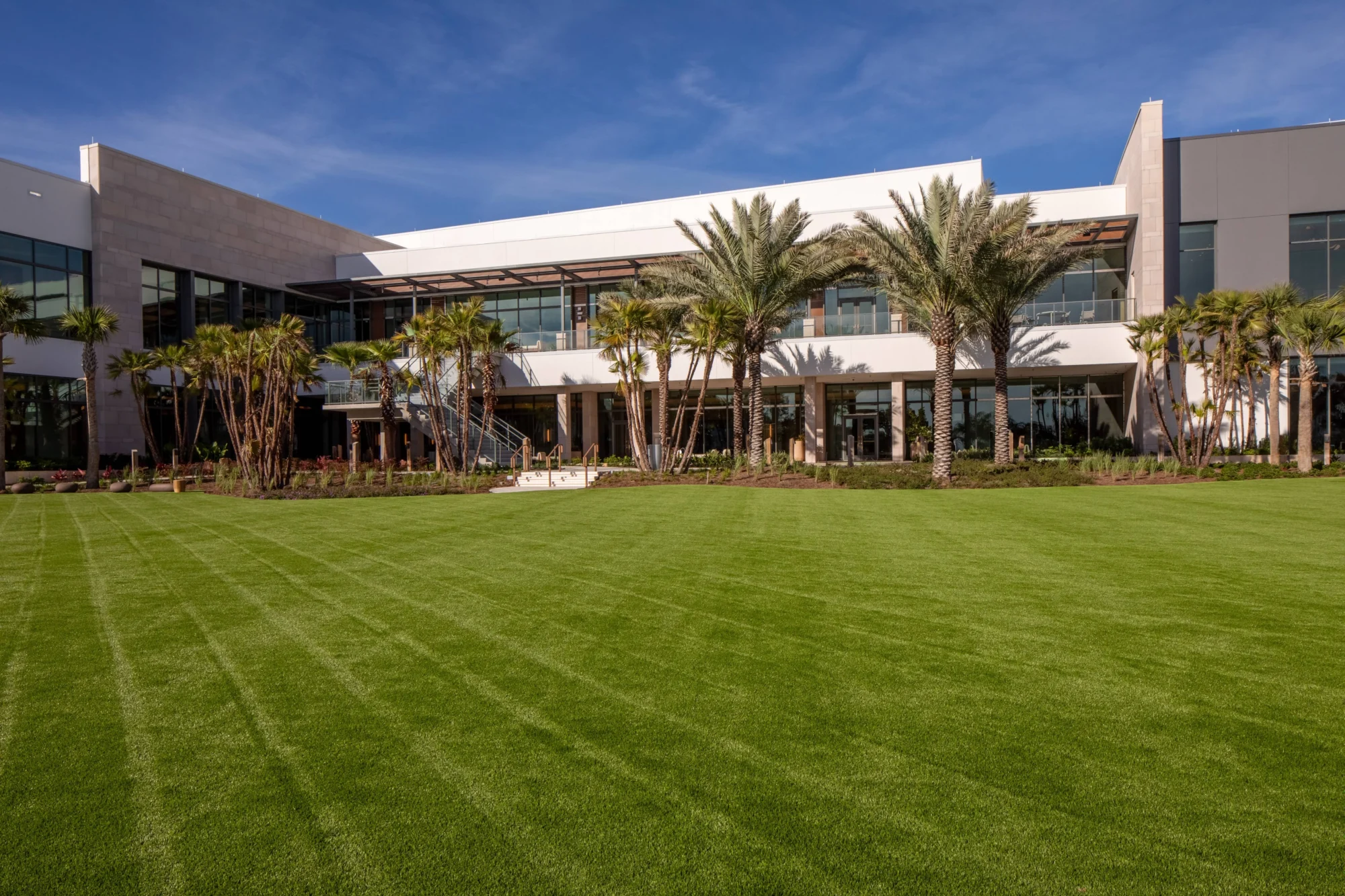 Modern building with a large lawn and palm trees at an Orlando wedding destination.