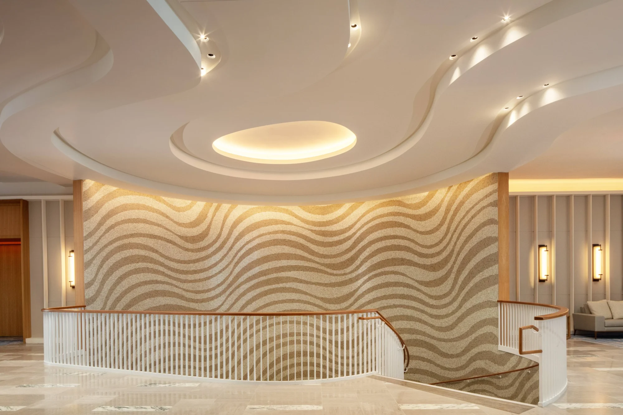 Elegant curved staircase at Conrad Orlando, a stunning Orlando wedding destination.