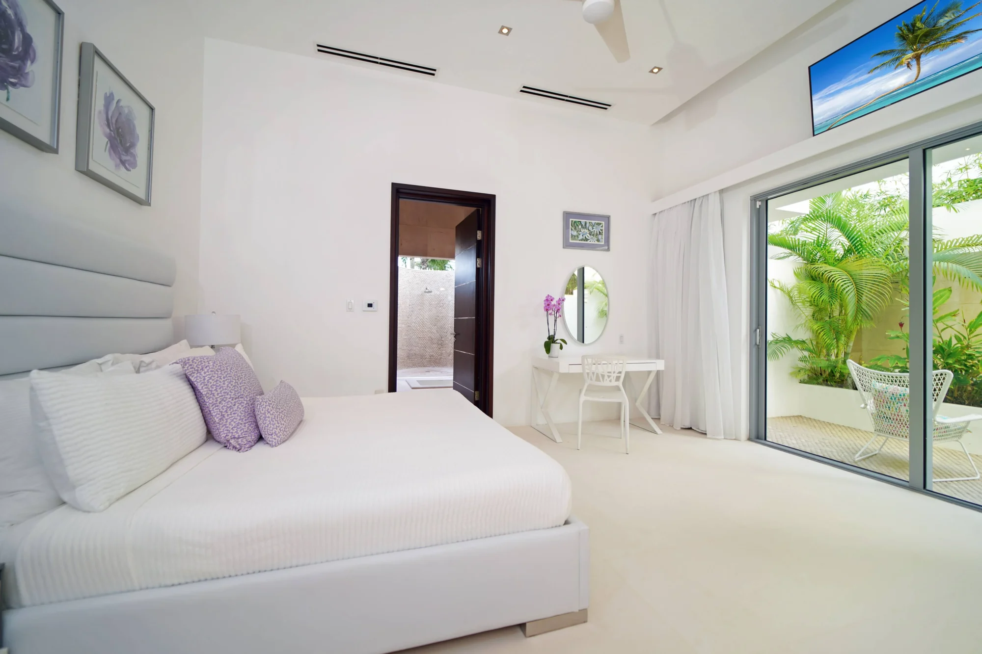 Luxurious Anguilla bedroom with private patio and outdoor seating. Perfect for a destination wedding.