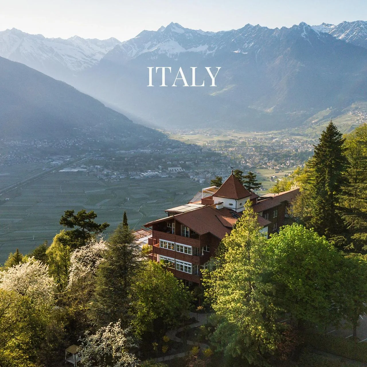 Italian Alps mountain view with a chalet; "Italy" text overlay