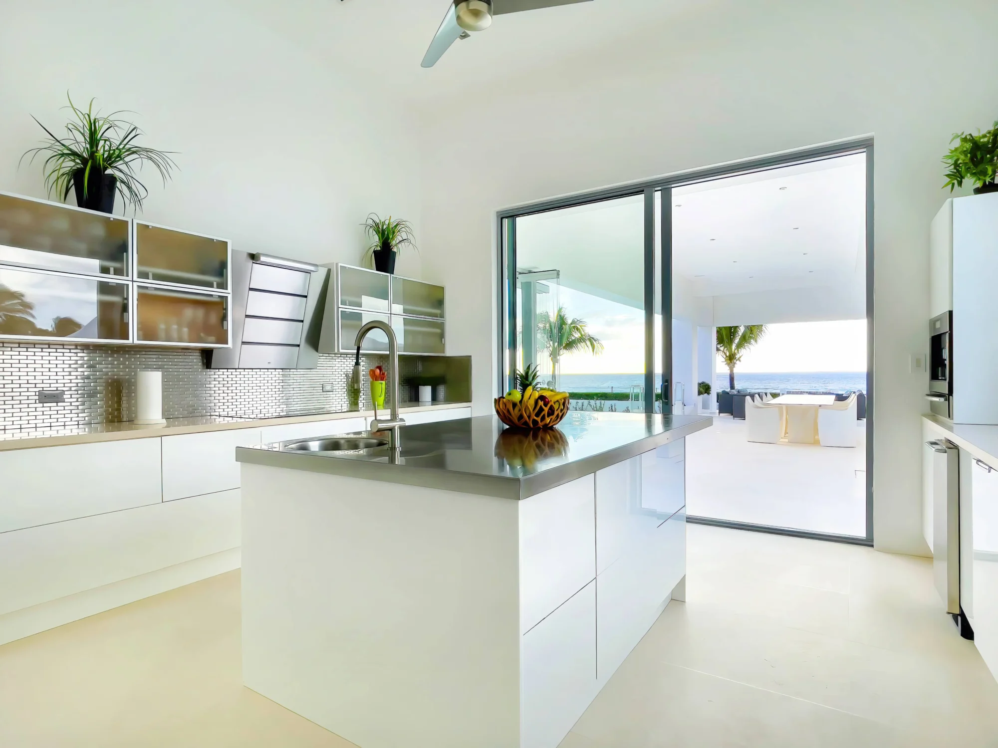 Modern white kitchen with ocean view; ideal Anguilla destination wedding venue.