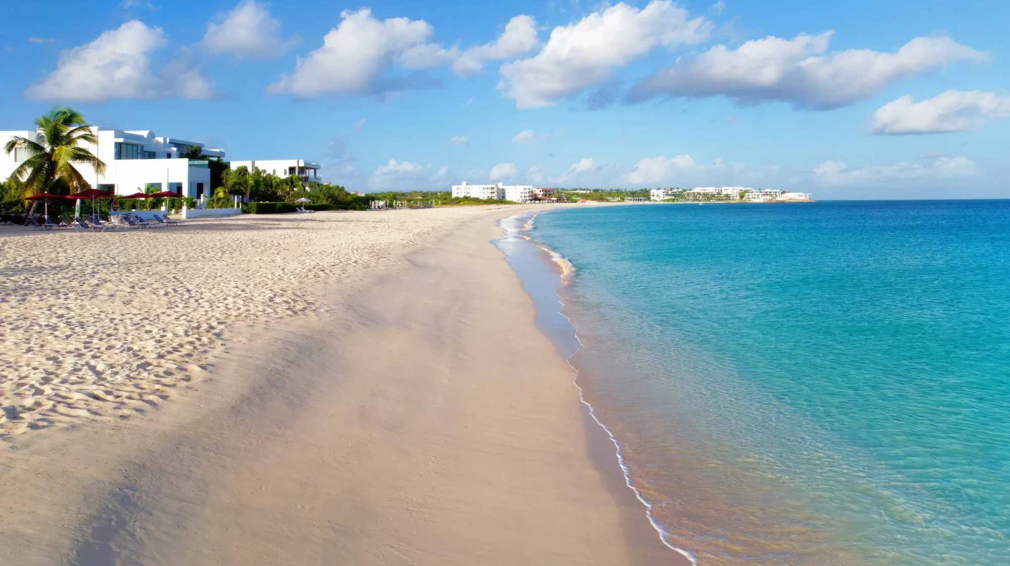 Stunning Anguilla beach with white buildings; perfect destination wedding location.