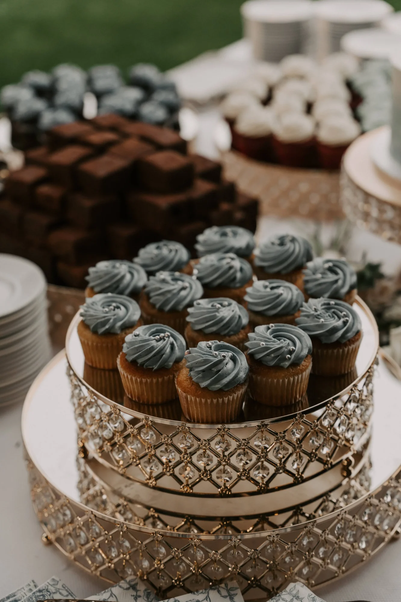 Cupcakes with blue frosting on a tiered dessert stand at an Orlando wedding destination.