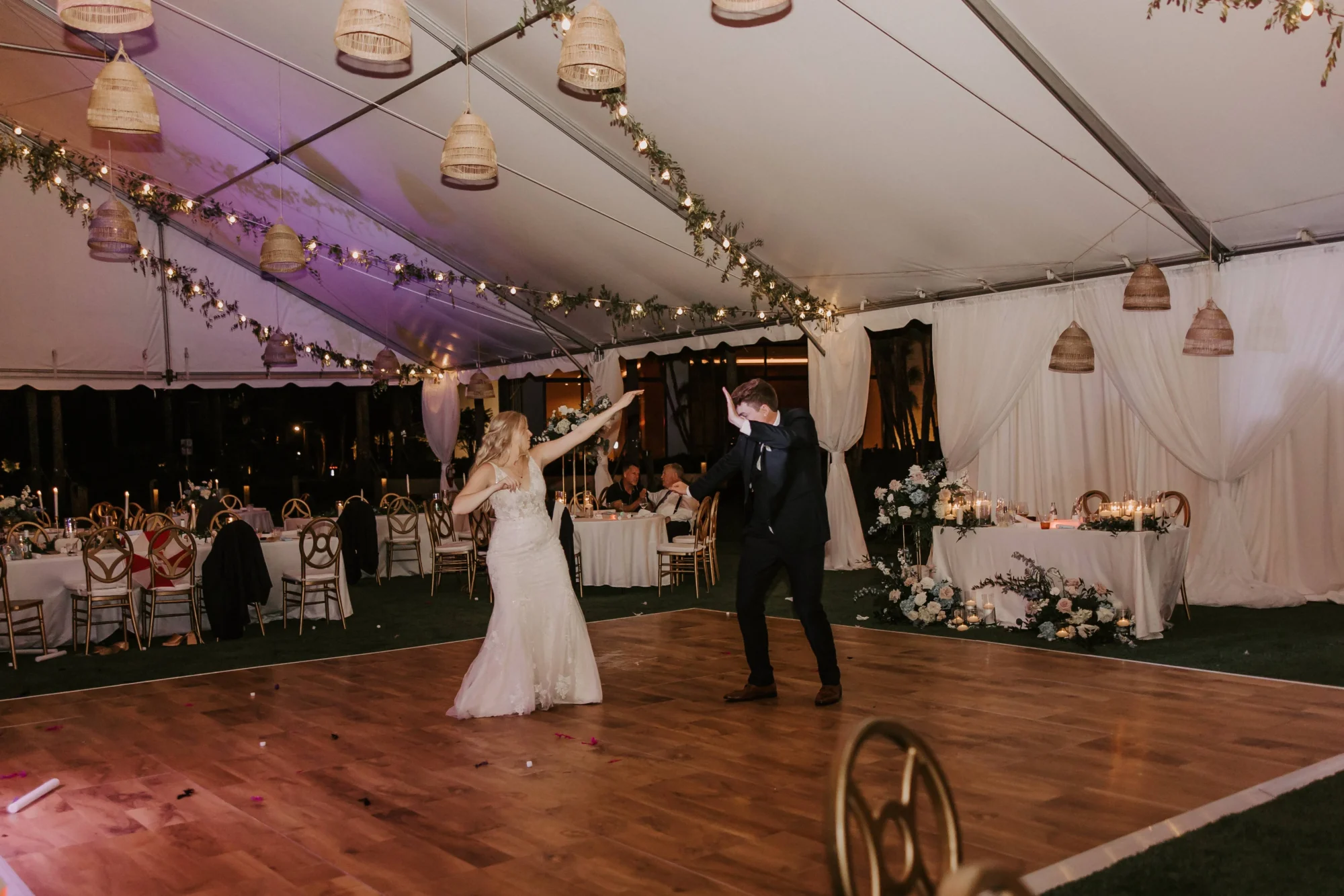 Bride and groom dancing at their Orlando wedding destination reception under a tent.