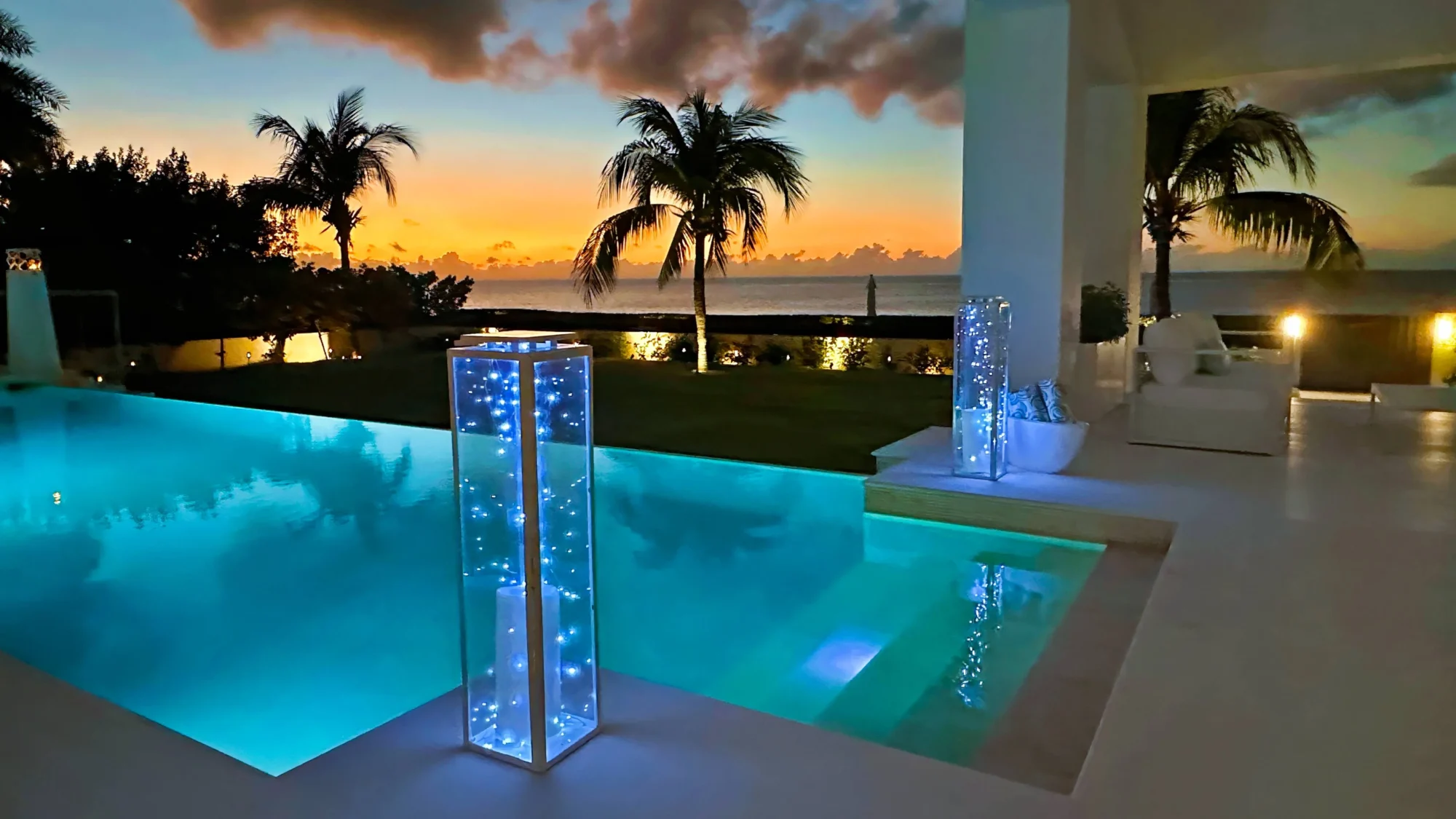 Tranquil Anguilla sunset view from a luxurious beachfront pool. Perfect for a destination wedding.