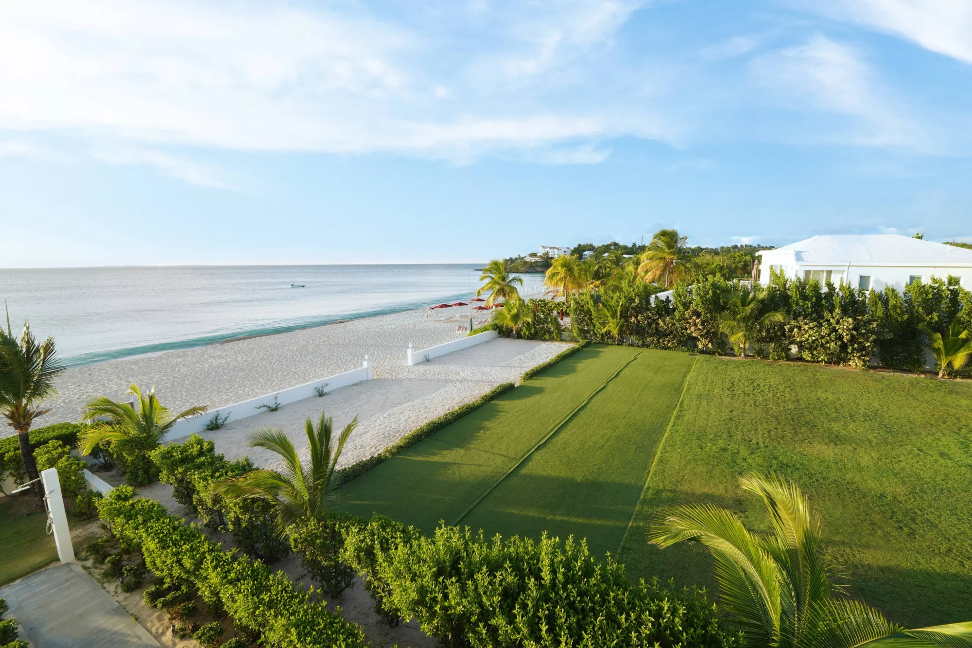 Luxury Anguilla beachfront property with lush landscaping, perfect for a destination wedding.