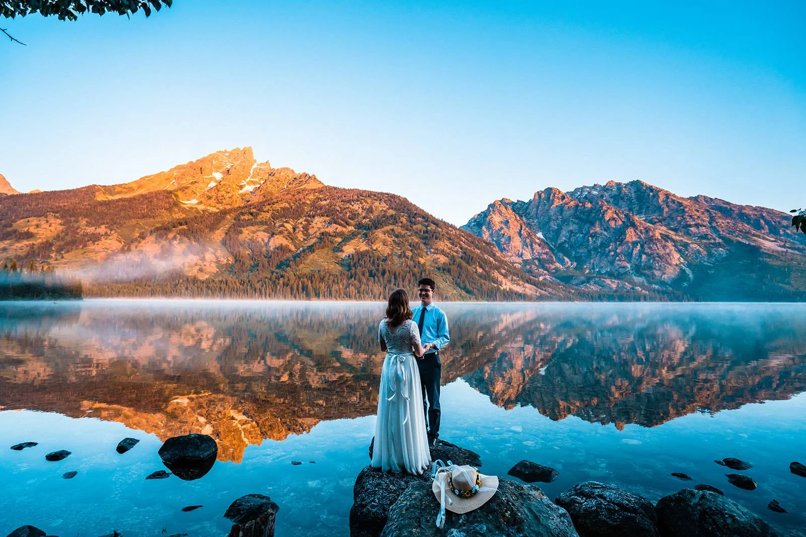 Couple eloping with Jackson Hole Wyoming wedding backdrop at sunrise