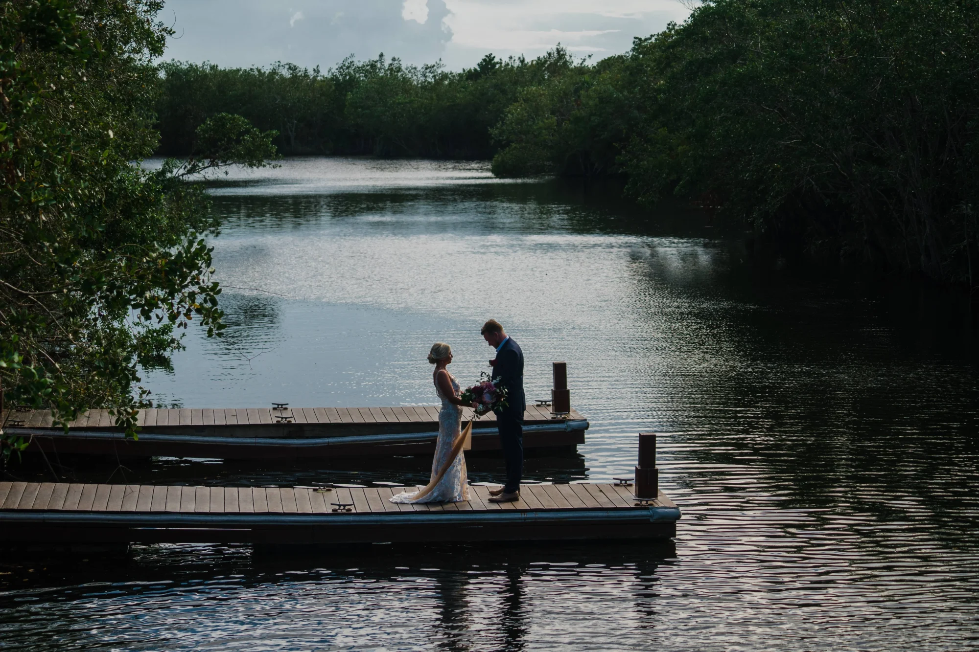 Couple on a Riviera Maya beach wedding dock at Fairmont Mayakoba
