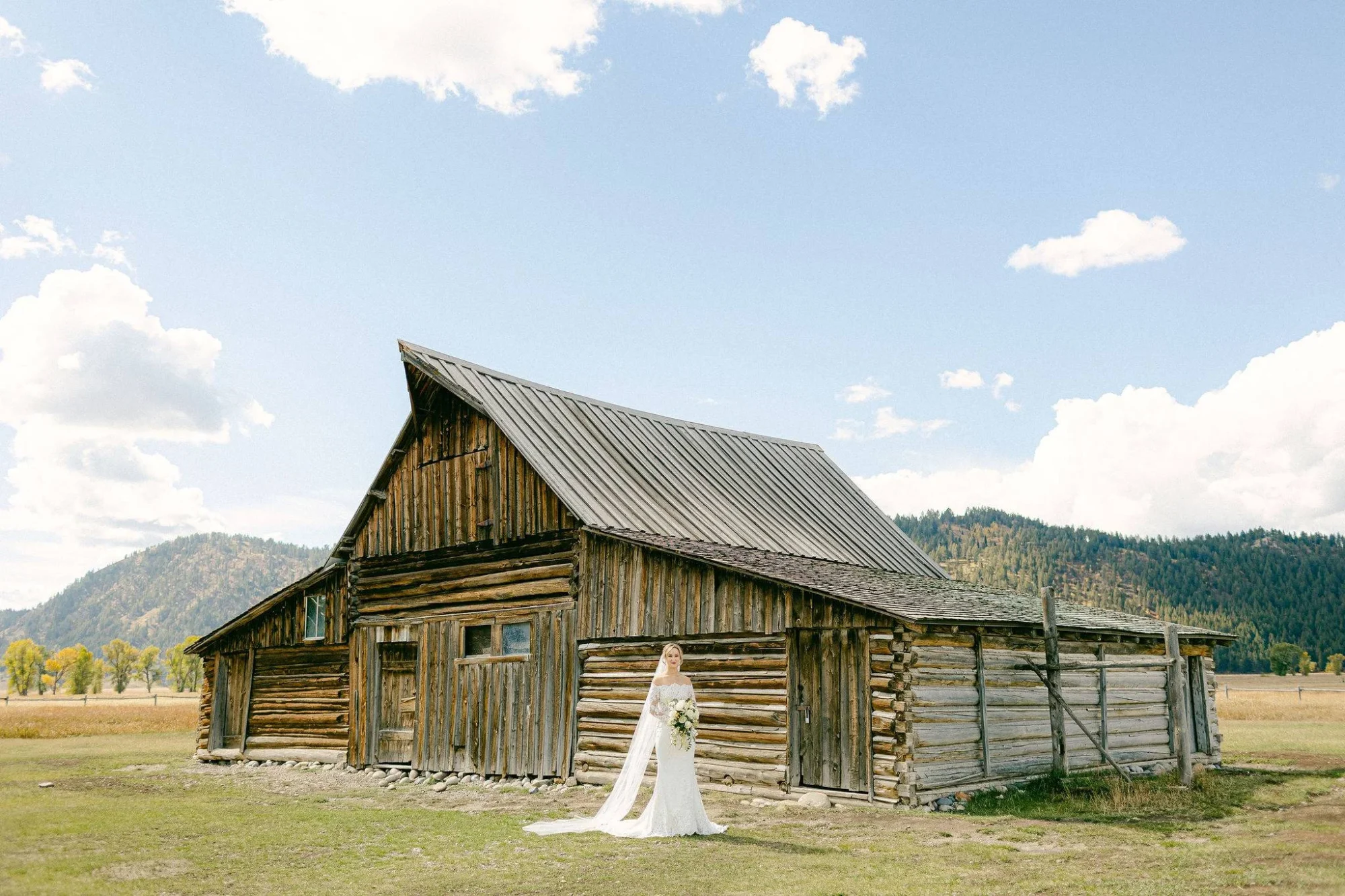 Bride in a wedding dress at a Jackson Hole Wyoming wedding with a rustic barn